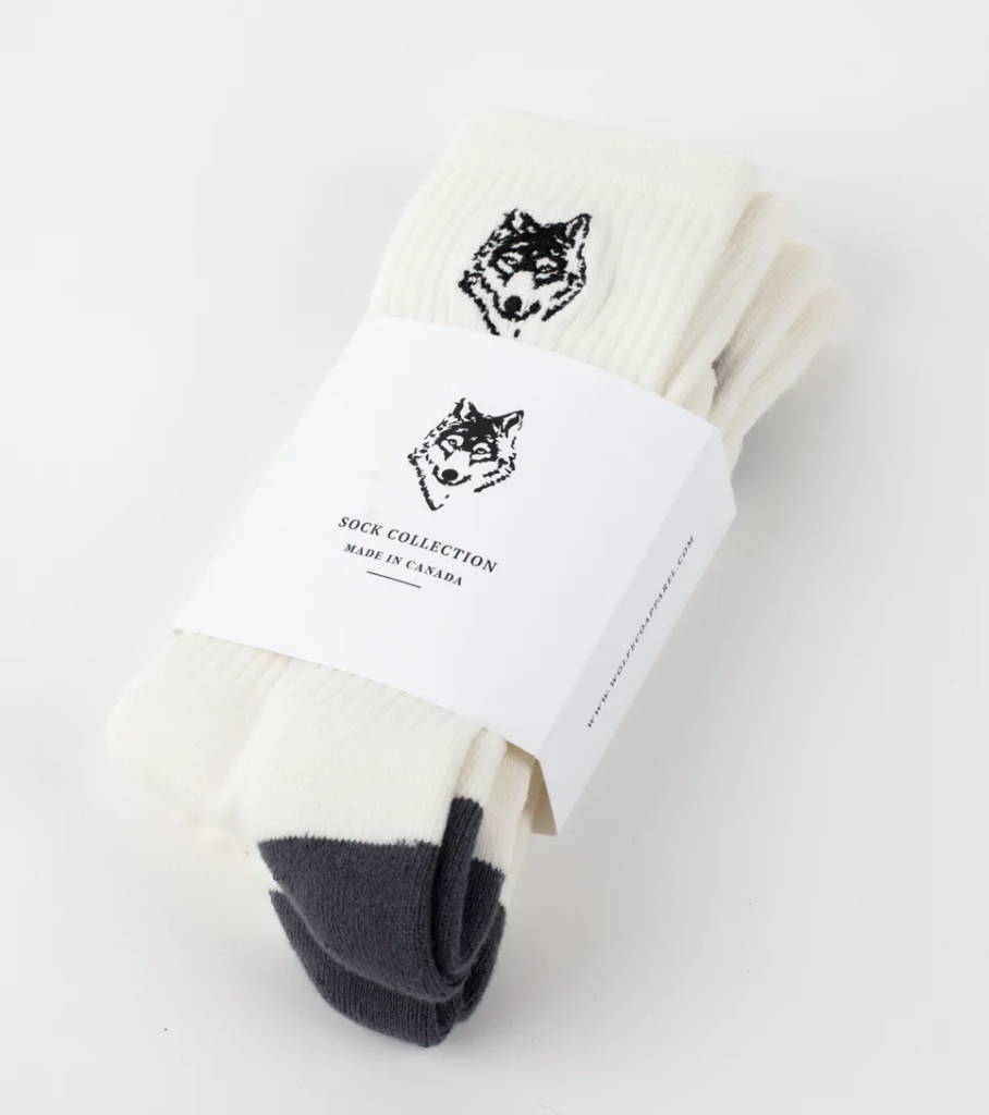 A three-pack of white Wolfe socks with a drawing of a wolf on each