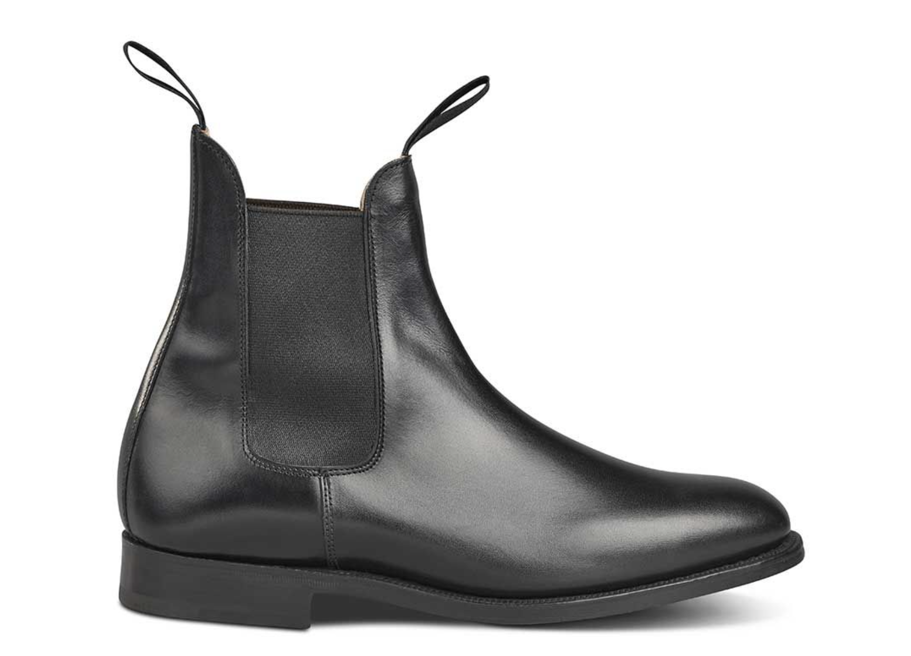 A black pair of handmade Trickers boots that look similar to Blundstones