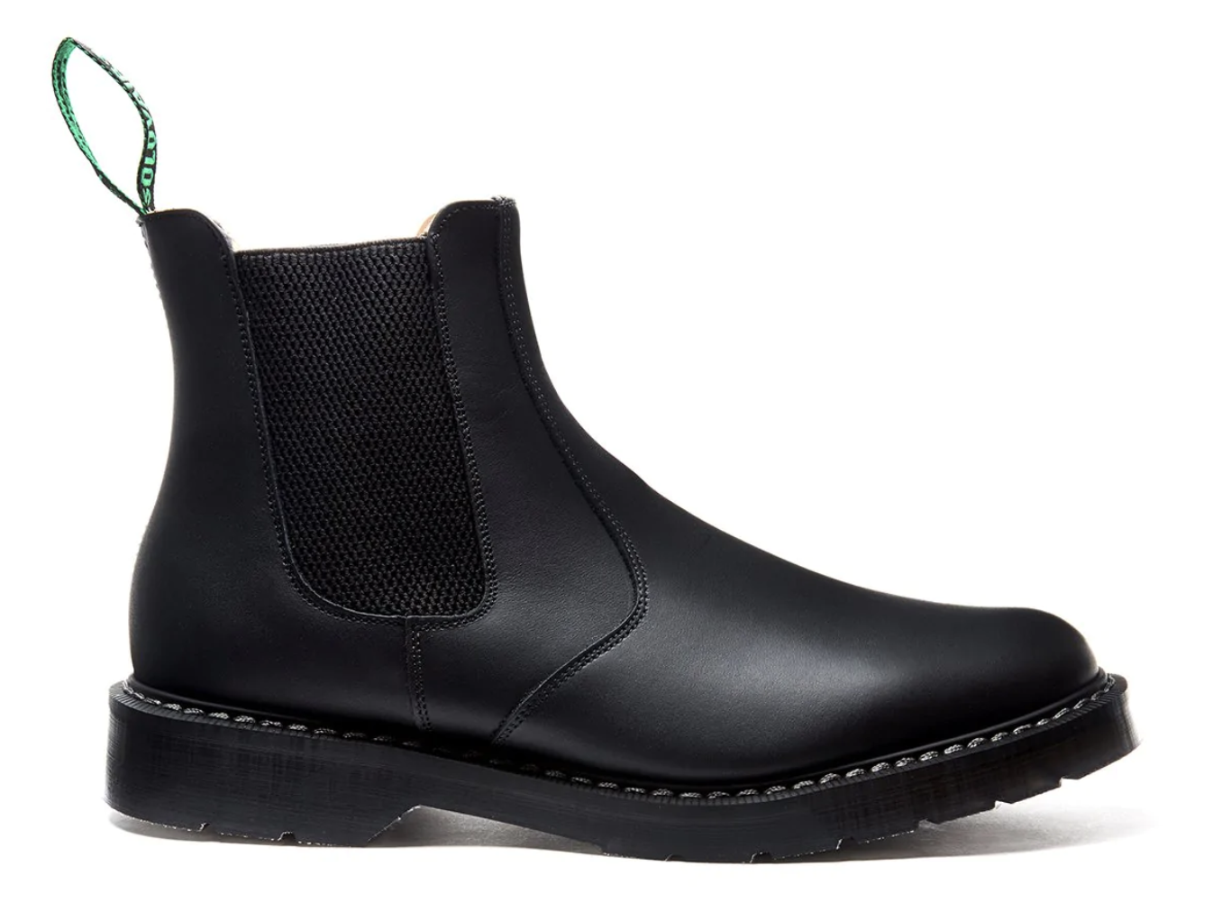 A black pair of Solovair boots that look similar to Blundstones on a white backgorund