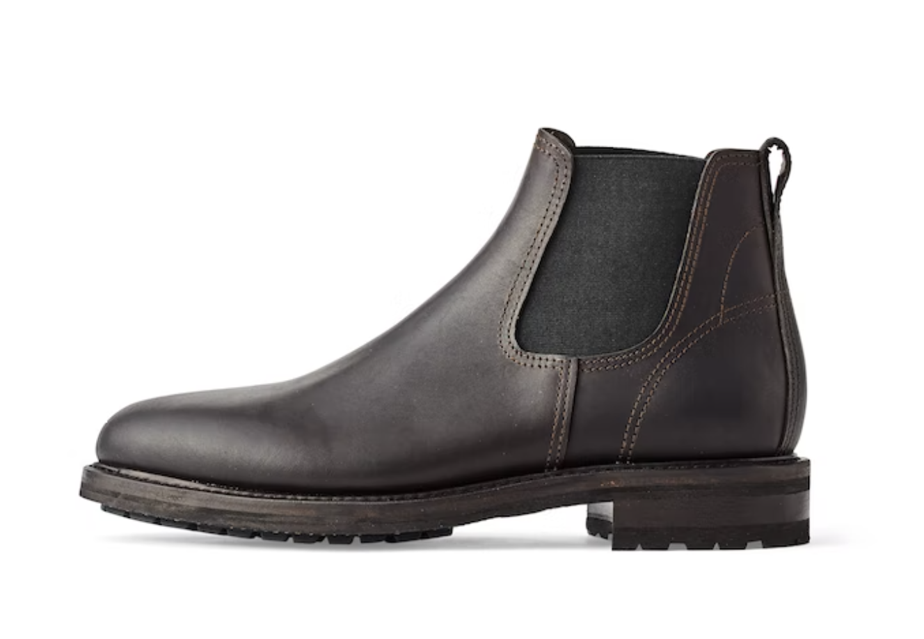 A black pair of contemporary Filson black boots on a white background