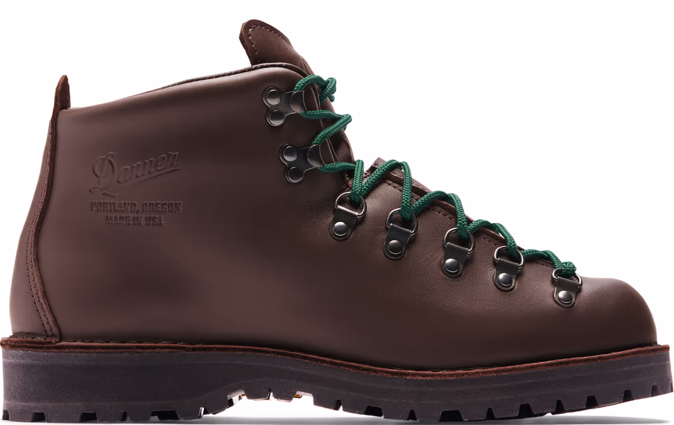 A brown pair of Danner boots with Green laces on a white background