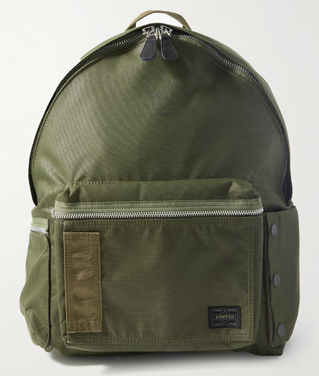 A dark green Porter Yoshida backpack with a silver zipper on a white background