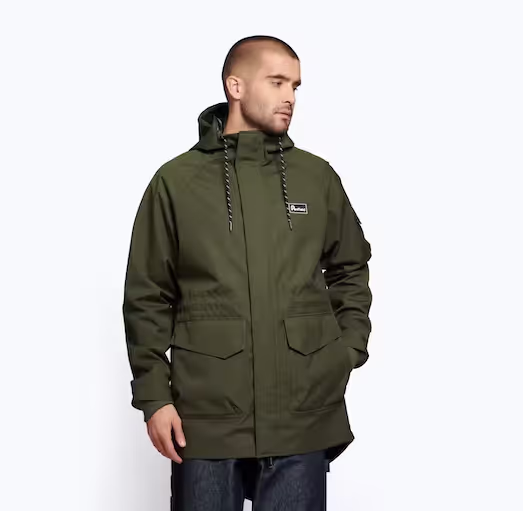 A man wearing a dark green Penfield winter jacket with dark jeans