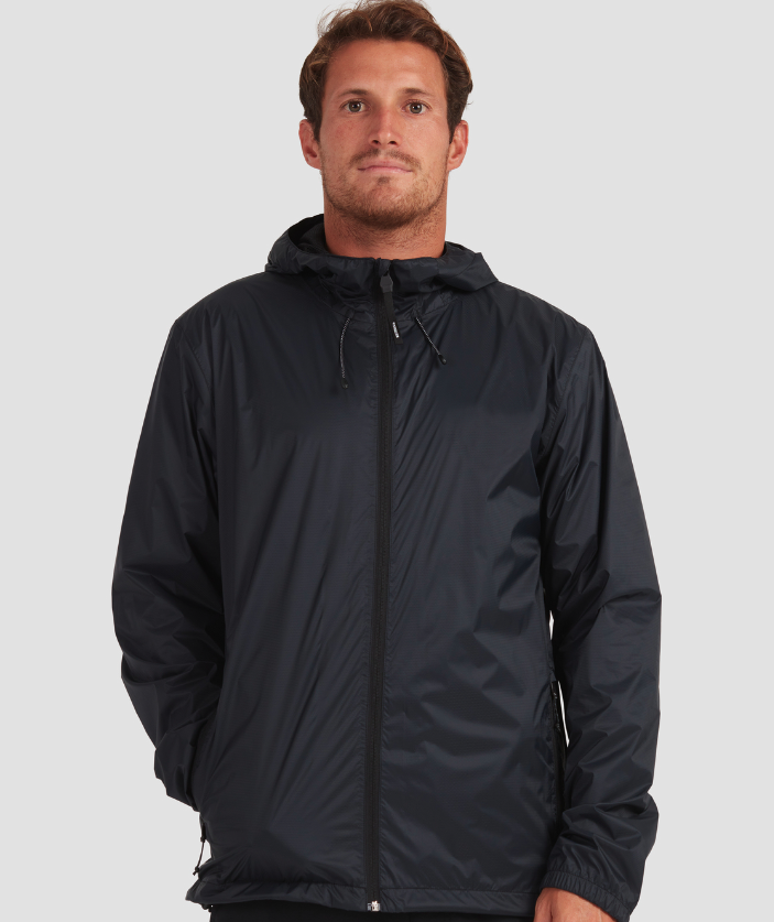 A man wearing a dark navy blue Quiksilver raincoat