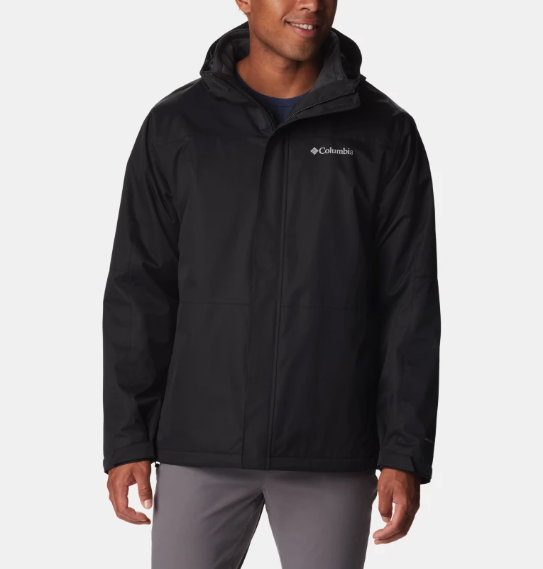 A man wearing a black Columbia winter jacket and dark grey pants