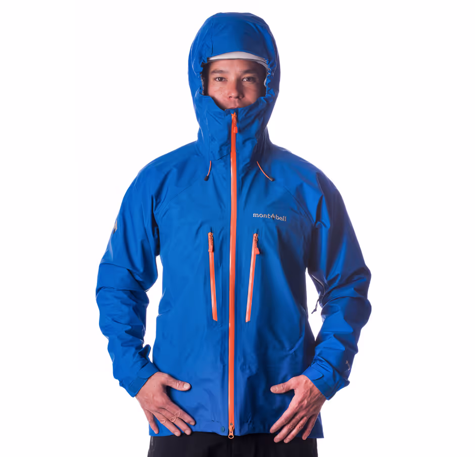 A man wearing a blue Monbell Winter jacket with the hood on