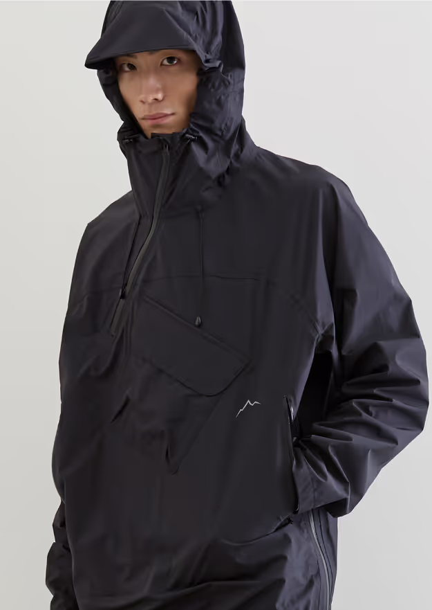A man wearing a black CAYL jacket with his hood on