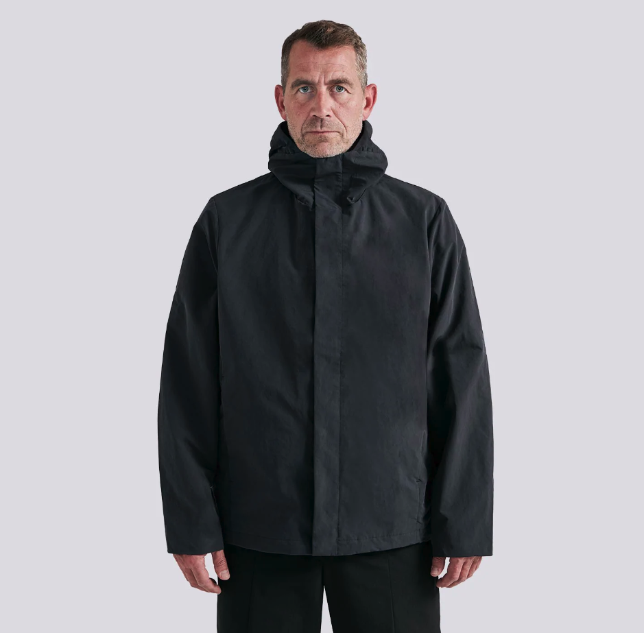 A man wearing a black Arys winter jacket and black pants