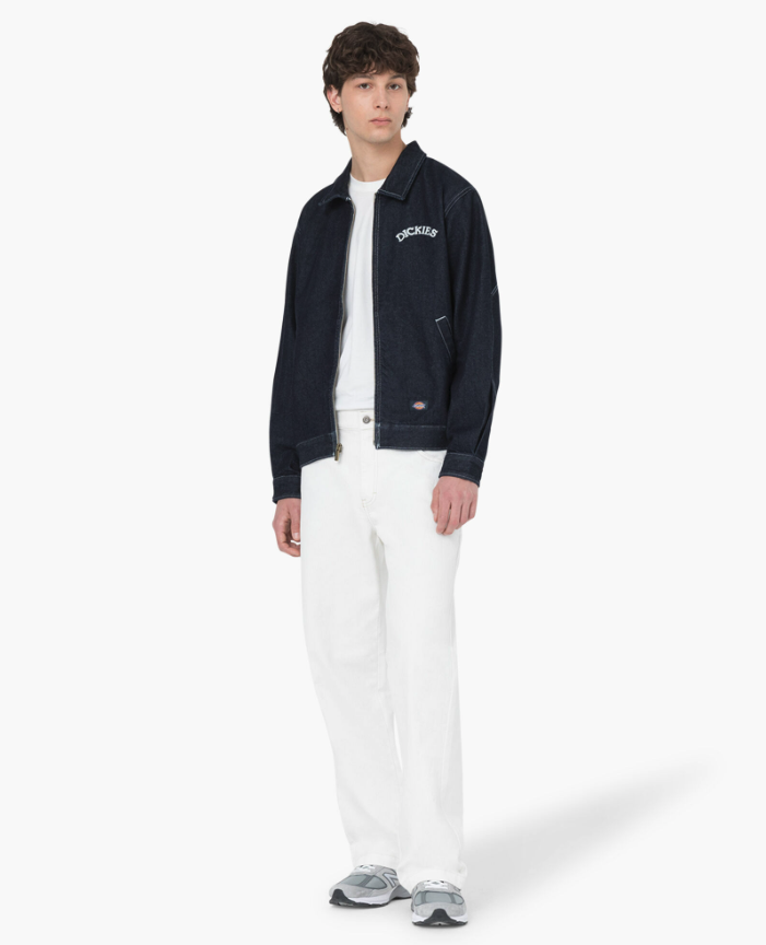 A man wearing denim dickies jacket and white workwear pants