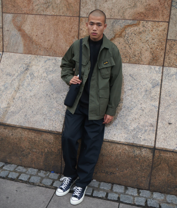 A man wearing a Stan Ray workwear button up and navy blue pants