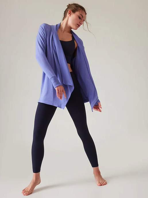 A woman wearing flowing Athleta yoga outfit in purple and dark navy blue