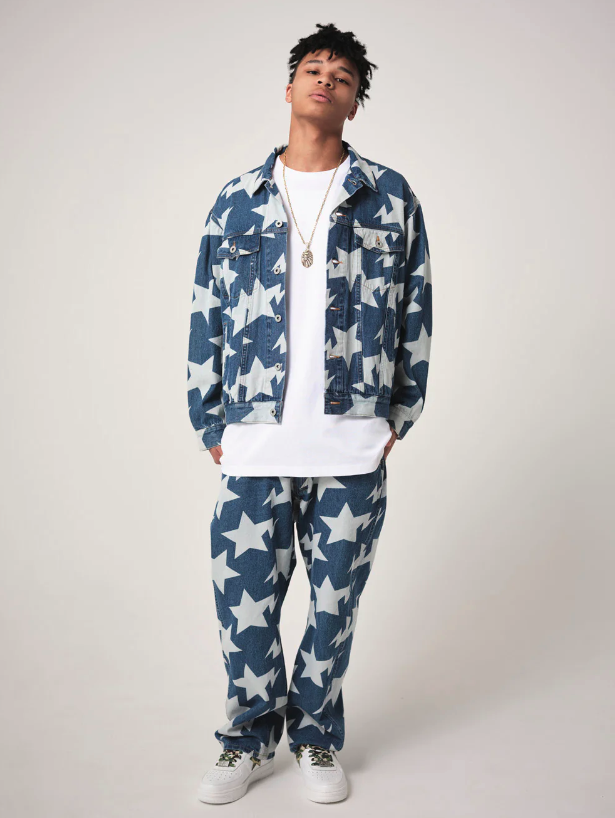 A man wearing a denim BAPE outfit with an all-over star print and a white t-shirt