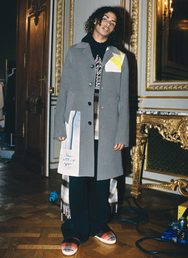 A man wearing a Lanvin overcoat with a hoodie underneath