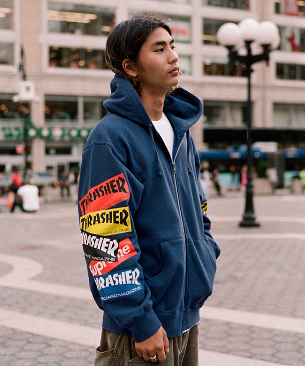 A man wearing a Thrasher Supreme Collaboration hoodie in dark blue