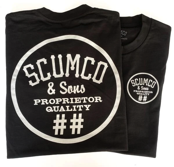 A close of of a Scumco & Sons t-shirt in dark grey with white text