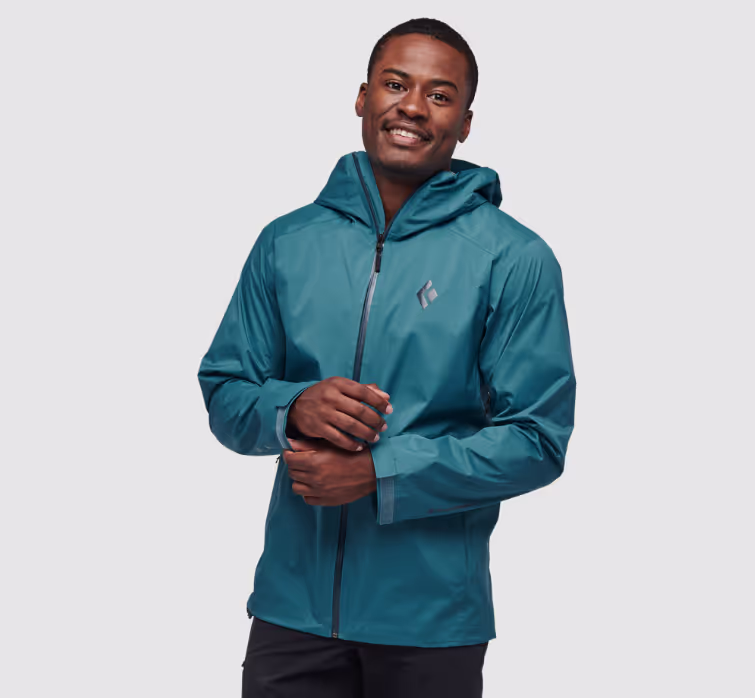 A man wearing a sleek Black Diamond blue windbreaker jacket