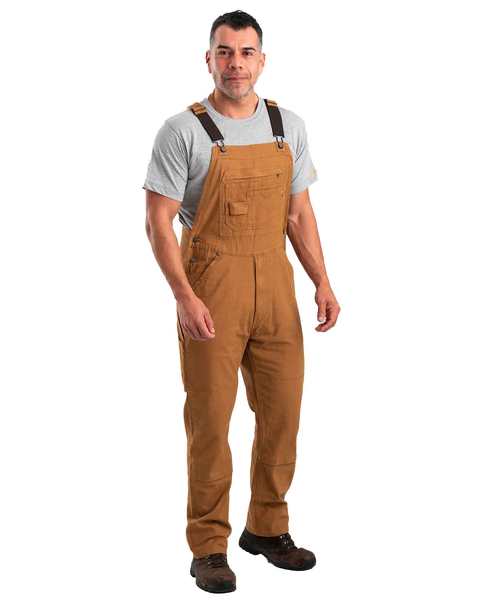A man wearing brown workwear overalls by Berne Apparel