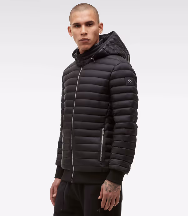 A man wearing a black Moose Knuckles puffy jacket