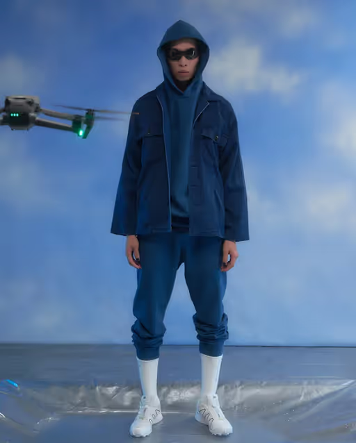A man wearing a full blue blue japan outfit with high white socks and shoes