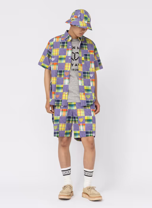A man wearing a full Human Made all over print outfit with matching bucket hat