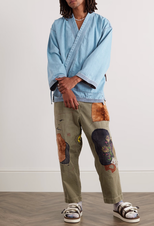 A woman wearing a Kapital denim Japanese style shirt with graphic pants