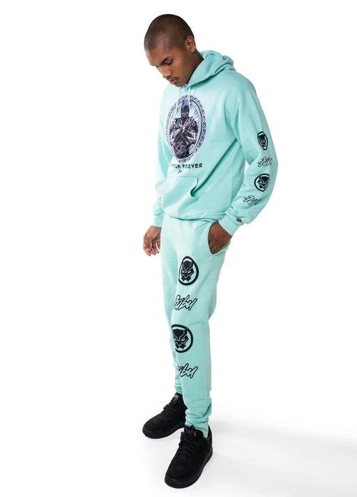 A man wearing a full light blue FUBU sweatsuit with graphics all over