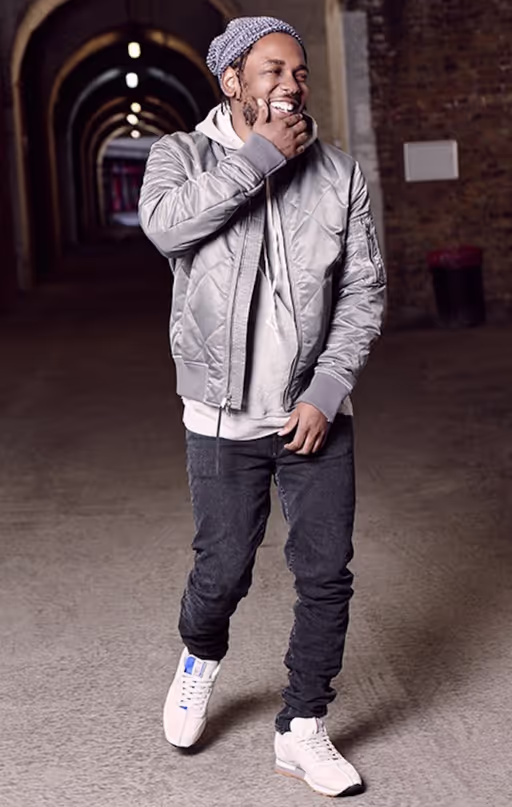 Kendrick Lamar wearing a reebok outfit with a lavender jacket and navy blue pants