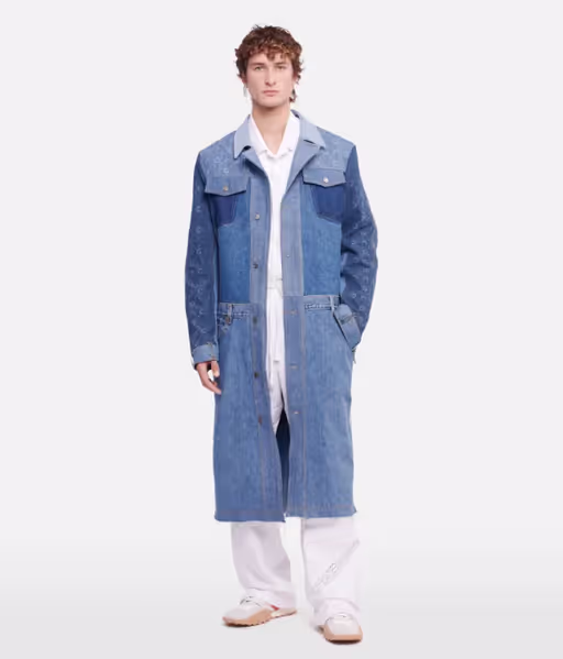 A man wearing a denim overcoat by Marine Serre and white pants and button ups