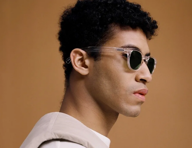 A man wearing a izipizi clear sunglasses