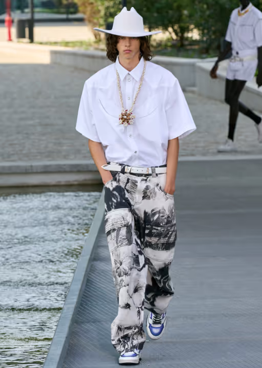 A man wearing a MSGM white short-sleeve, a cowboy pants and wide pants