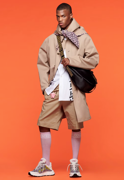 A man wearing a Versace outfit layered in different browns