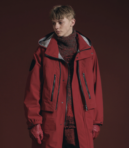 A man wearing a dark red Viridi-Anne jacket and turtleneck along with red gloves