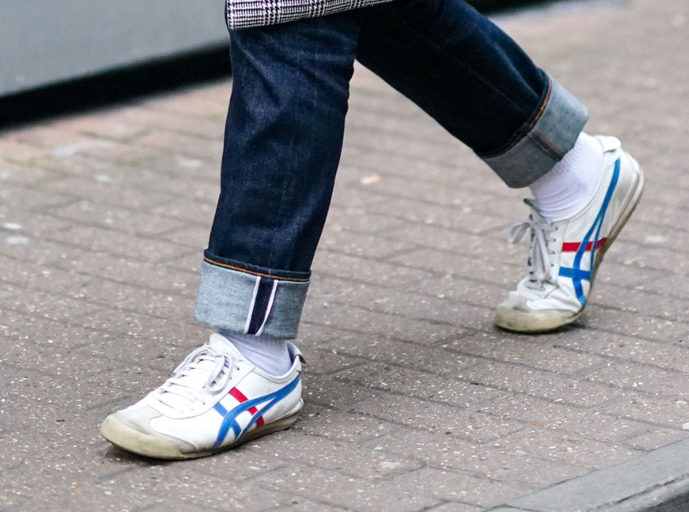 A man wearing a Onitsuka Tiger branded shoes and denim
