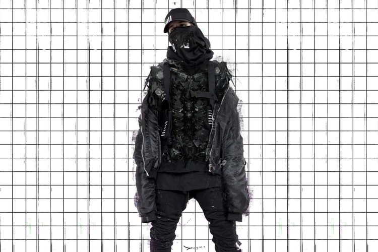 A man wearing a black 0608wear techwear outfit featuring jacket, mask and hat