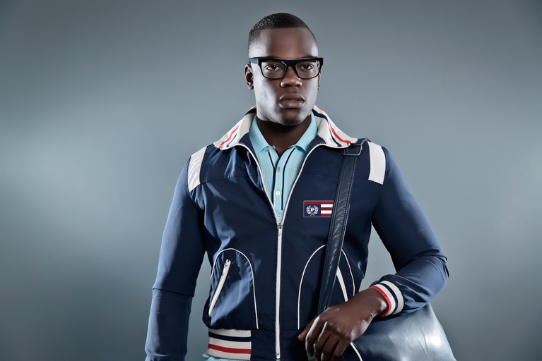A man wearing a PHAT FARM zip up and a modern blue button up