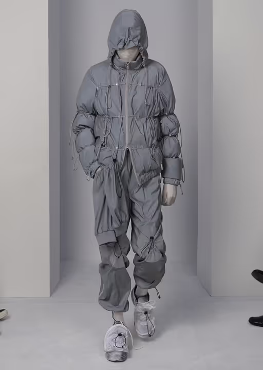 A man wearing a futuristic Post Archive Fashion technical outfit