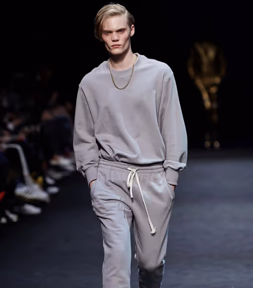 A man wearing a grey sweatsuit by Pushbutton