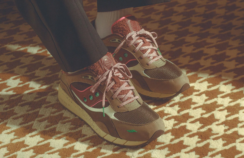 A man wearing a pair of brown and colorful Saucony runners