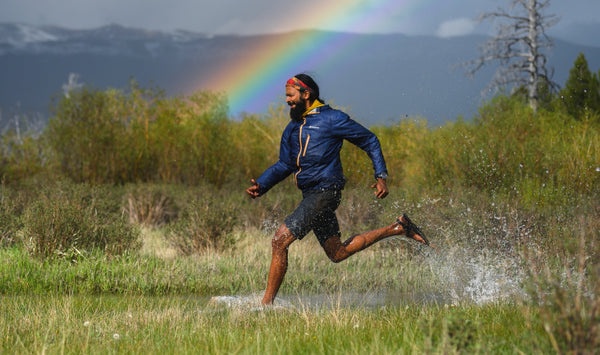 A man wearing a pair of Bedrock Sandals running