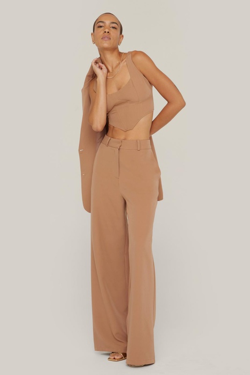 A woman wearing a NastyGal brown outfit