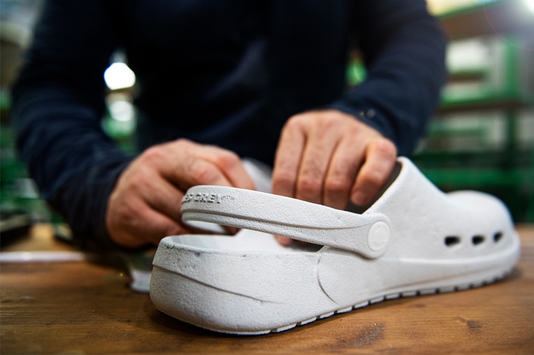 A man showcasing a pair of Ales grey slip-on shoes
