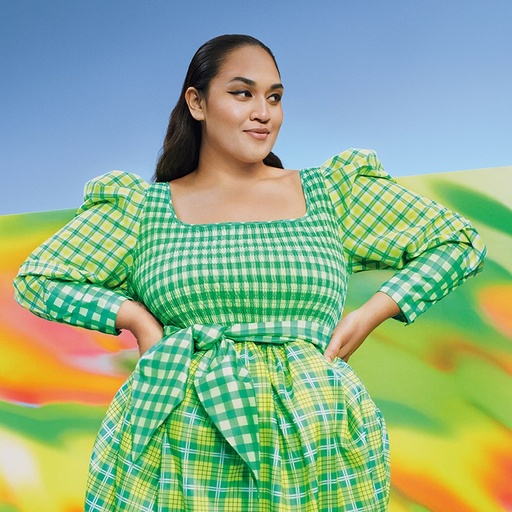A woman wearing a green Target dress in green and yellow