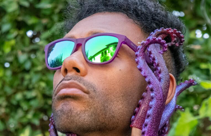 A man wearing Purple Goodr sunglasses