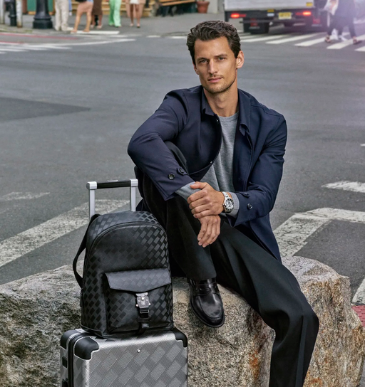 A man wearing a Montblanc suit in navy blue with a grey shirt