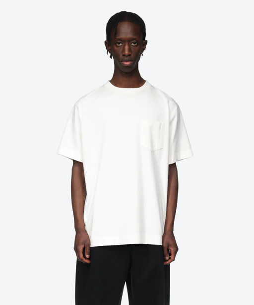 A man wearing a white Simone Rocha t-shirt and black pants