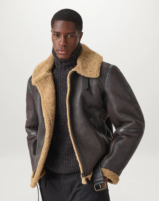 A man wearing a black leather Blestaff jacket with brown fur