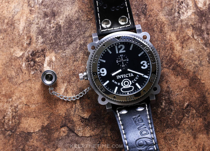 A close-up of an Invicta black watch