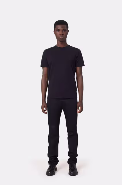A man wearing a Colorful Standard deep black t-shirt