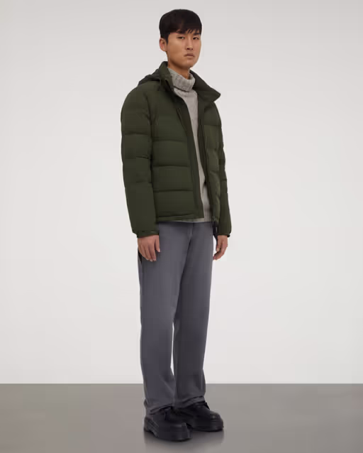 A man wearing a ASPESI green nylon quilted jacket