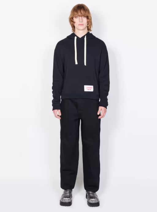 A man wearing a Charles Jeffrey LOVERBOY black ears hoody